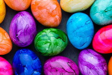 Easter eggs painted in colors on a pattern background.