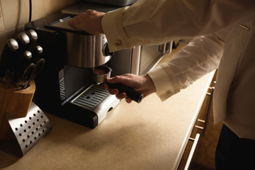 Barista prepares coffee in coffee machine