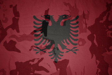 flag of albania on the khaki texture . military concept