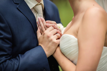 Groom holding hands of bride with engagement ring. Wedding love 