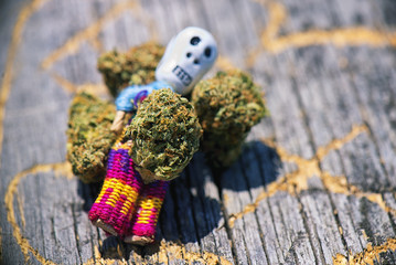 Dried cannabis buds (Death Bubba strain) over wood pattern - med