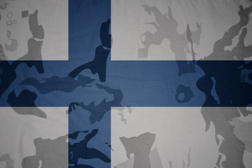 flag of finland on the khaki texture . military concept