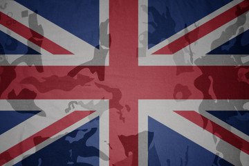 flag of great britain on the khaki texture . military concept