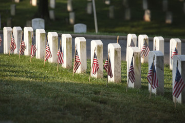 Naklejka premium Grave markers with flags at Arlington National Cemetery on Memor