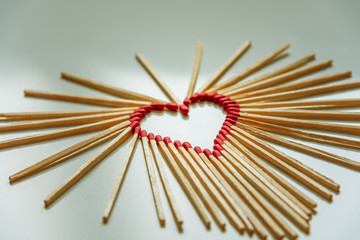 closeup of matchsticks arranged to form a heart