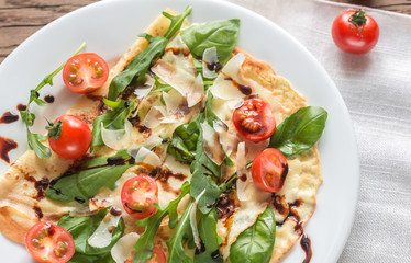Crepes with cherry tomatoes, italian cheese and arugula