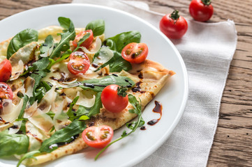 Crepes with cherry tomatoes, italian cheese and arugula