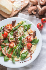 Crepes with cherry tomatoes, cheese, mushrooms and arugula