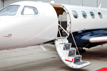 Ladder with open door in business jet airplane