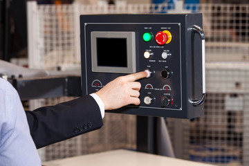 Operator hands on lcd screen of CNC machine