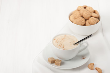 Amaretti Biscuits. Cup Of Cappuccino Coffee. Lump Demerara Sugar