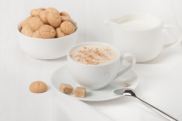 Amaretti Biscuits. Cup Of Cappuccino Coffee. Lump Demerara Sugar