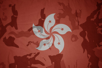 flag of hong kong on the khaki texture . military concept
