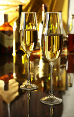 Glass of wine, brandy or cognac on the mirror wooden table