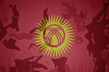 flag of kyrgyzstan on the khaki texture . military concept