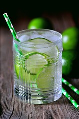 Homemade iced lemonade lime in a crystal glass on the old wooden background.