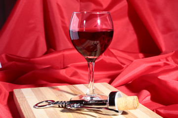 Still life with red wine grapes and chees on wooden table.