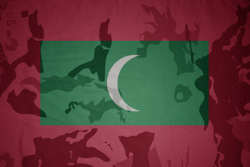 flag of maldives on the khaki texture . military concept