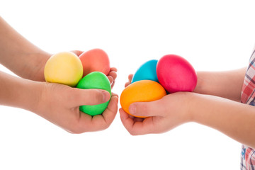 pile of colorful easter eggs in two child hands