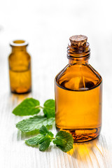 organic cosmetics with herbal extracts of mint on wooden background