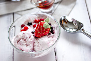 organic homemade ice cream in glass bowl on wooden background