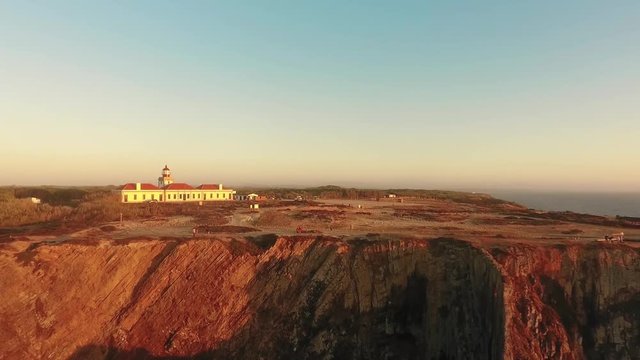 Lighthouse on the beautiful cliff at sunset in Portugal