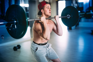 Fototapeta na wymiar male bodybuilder training at gym. professional athlete working out