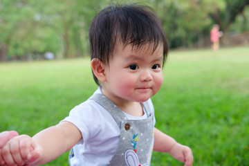 Cute Baby girl playing in the garden, close-up portrait, Portrait of a beautiful baby girl