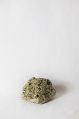 Large chunk rock of pyrite fools gold over isolated white background