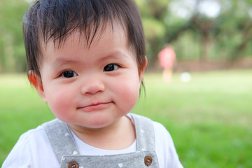 Cute Baby girl playing in the garden, close-up portrait, Portrait of a beautiful baby girl
