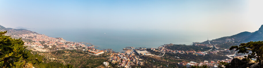 Fishing villages and Yellow sea panorama from Na Luo Yan Ku trail in Laoshan Mountain, Qingdao,...