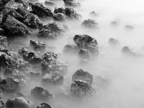 Fototapeta Long exposure black and white image of stone in the sea