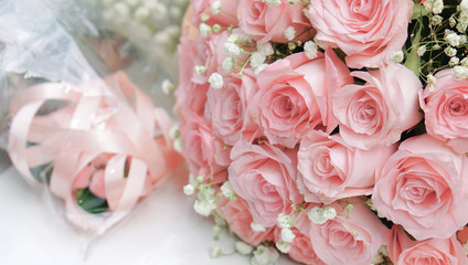 Bouquet of light pink roses on white table, close up