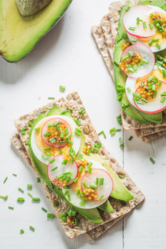 Healthy sandwich with avocado, chive and eggs