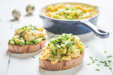 Homemade fried eggs with avocado and chive