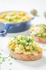 Homemade scrambled eggs with avocado and chive