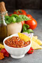 Homemade spicy tomato salsa with vegetables and olive oil