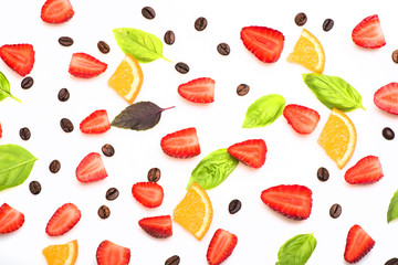 coffee beans, strawberry, orange, sheets of basil on white background