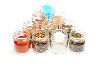 various spices in jars on white background