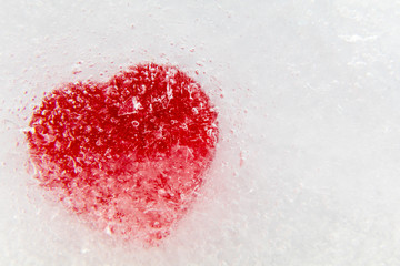 Red heart frozen in ice background and room for copy