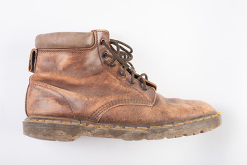 Pair of old brown working boots Isolated on white background.