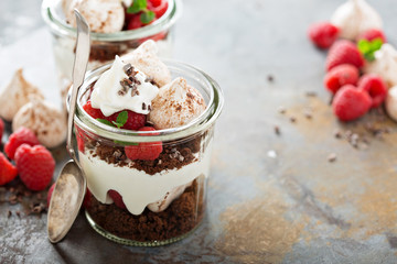 Layered dessert with chocolate cake and whipped cream