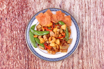 Fried mixed fruit and vegetable with roasted chili plate .