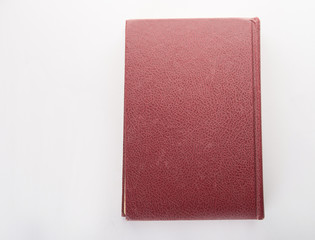 Red leather notebook isolated on white background.