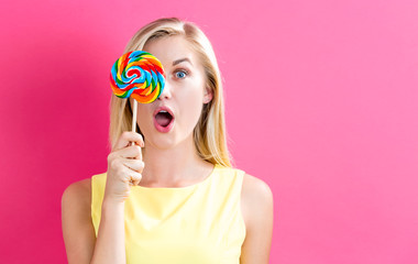 Young woman holding a lollipop