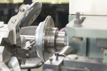 The CNC  spinning machine forming the part in the factory