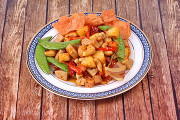 Fried mixed fruit and vegetable with roasted chili plate .