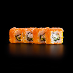 traditional fresh japanese sushi rolls on a black background