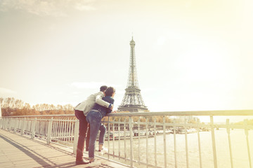 Fototapeta na wymiar Multi-ethnic Couple Having Fun In Paris Near Eiffel Tower