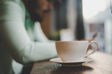 Man with coffee cup in cafe.